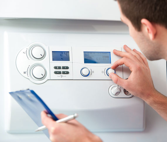 Photo of a Calgary HVAC technician adjusting data centre thermostat